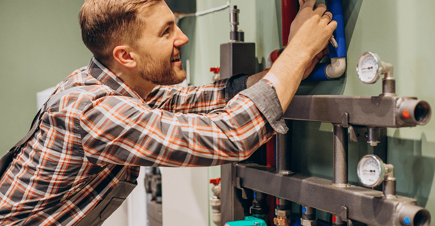 Technician working on a residential heating manifold